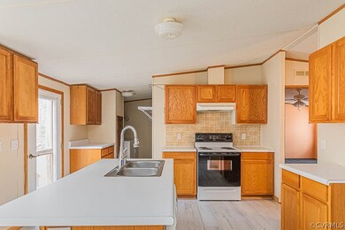 Kitchen with white range with electric stovetop, c