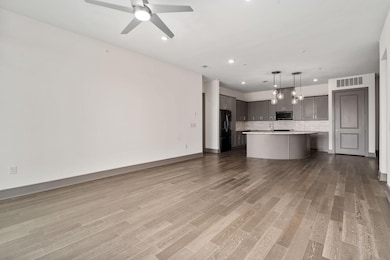 Kitchen featuring gray cabinetry, ceiling fan, han
