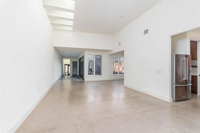 Unfurnished living room featuring a high ceiling,