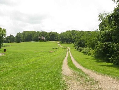 Exterior Front. 900 foot driveway leading to home.