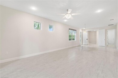 Empty room featuring baseboards, ceiling fan, visi