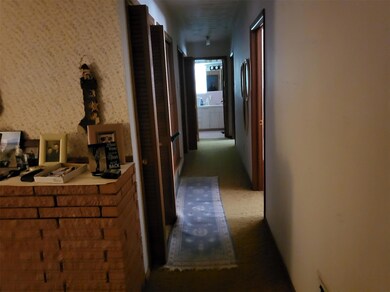 Hallway featuring carpet flooring