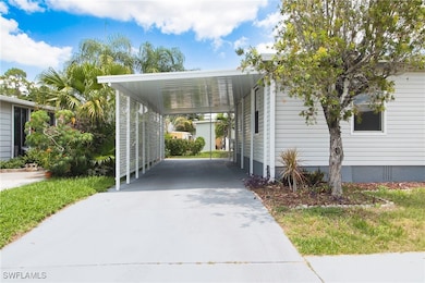 View of car parking with driveway and a carport