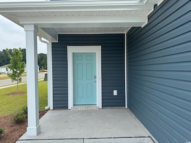Doorway to property with a lawn