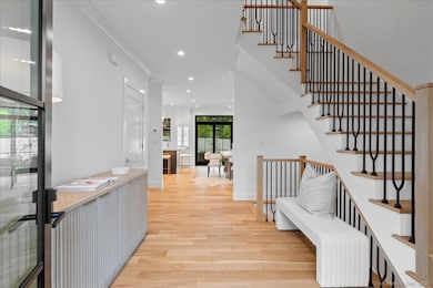Grand foyer with 9-foot ceilings, a sweeping staircase with views to the back of the house.