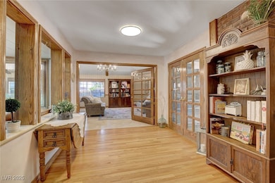 Entryway with French doors, light wood-type floori
