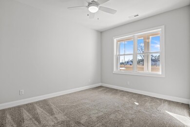 Carpeted empty room with ceiling fan