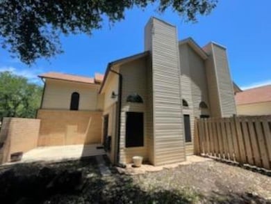 Back of house with fence and a chimney