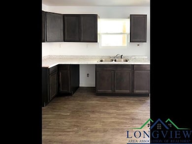 Kitchen with light countertops, a sink, and light wood-style flooring