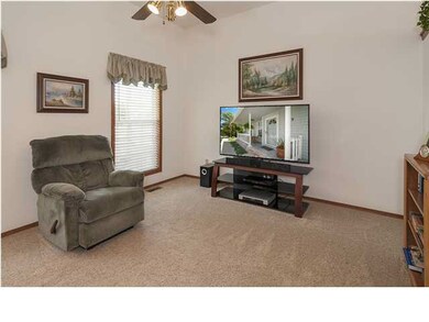 Main floor living room with ceiling fan.