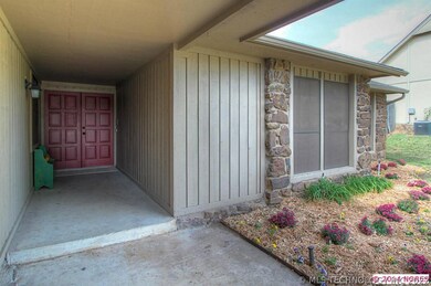 Large covered patio & Red double door entry