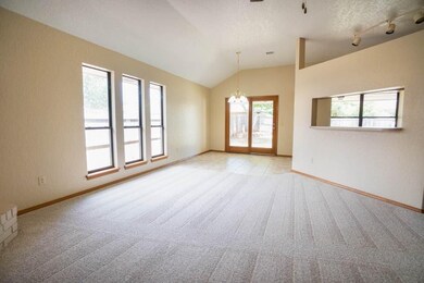 Family room view to kitchen dining and eating bar.