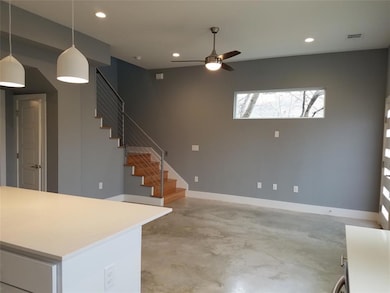 Living room featuring visible vents, concrete flo