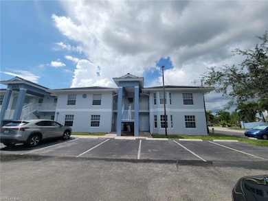 View of building exterior featuring uncovered parking