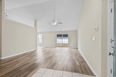 Unfurnished living room with ceiling fan, light ha