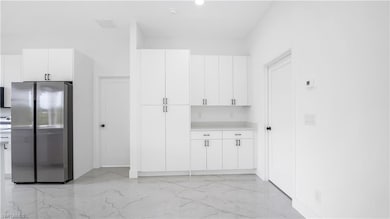 Kitchen featuring light countertops, marble finish