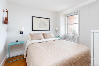 Bedroom with wood finished floors and baseboards