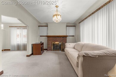 Carpeted living area with a chandelier, a fireplace, and arched walkways