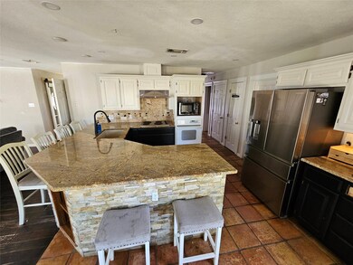 Kitchen featuring white appliances, white cabinets