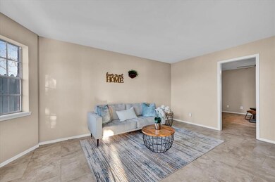 Kitchen featuring backsplash, white cabinets, appl
