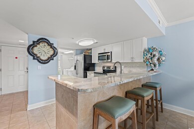 Kitchen with white cabinetry, light tile patterned