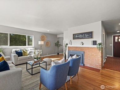 Cozy main floor Livingroom with natural gas fireplace and hardwood flooring