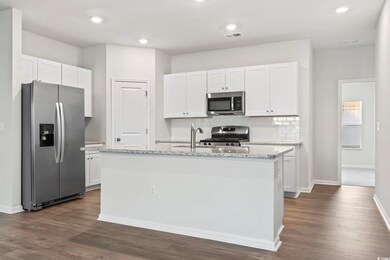 Kitchen featuring stainless steel appliances, dark