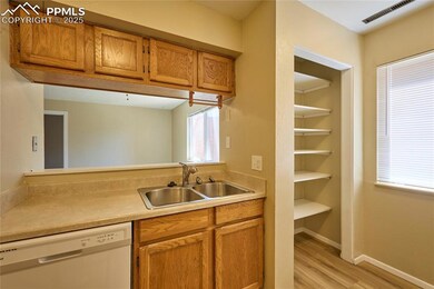 Kitchen featuring white dishwasher, a sink, light 