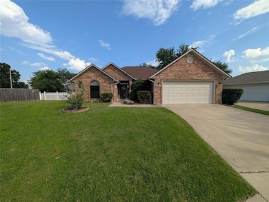 Ranch-style home featuring brick siding, concrete driveway, and a garage
