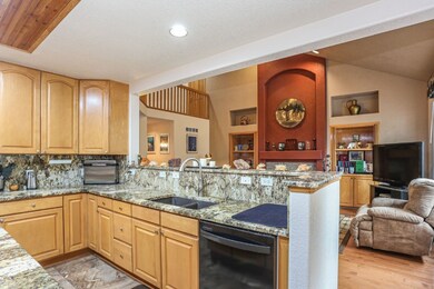 Granite counter tops in huge kitchen which is open