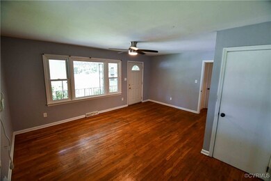 Empty room with baseboards, a ceiling fan, and dar