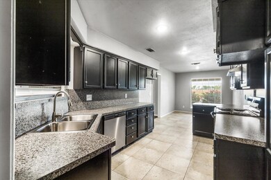 Kitchen featuring tasteful backsplash, wall chimne