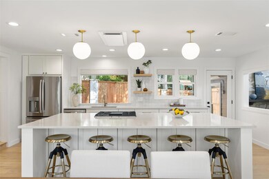 Kitchen with light wood-style flooring, stainless