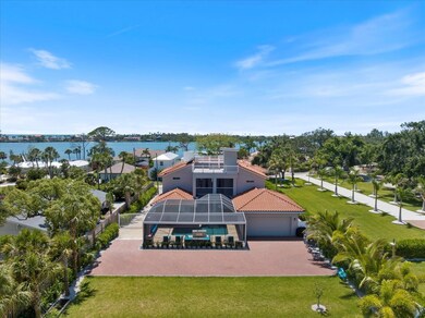 Aerial view of the property with paver driveway and lawn area.
