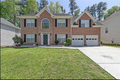 Colonial house with brick siding, concrete drivewa