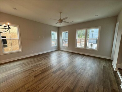 Empty room with dark wood-type flooring, ceiling f