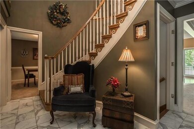 Glorious staircase with oak end caps wrap this 2 story entry.