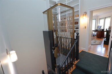 Hallway with hardwood / wood-style flooring