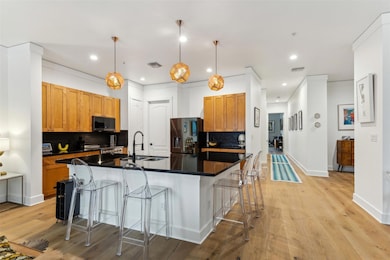 Kitchen with a kitchen island with sink, a sink, a