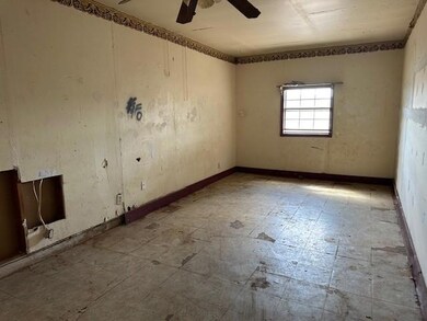 Spare room with ceiling fan and tile patterned flo