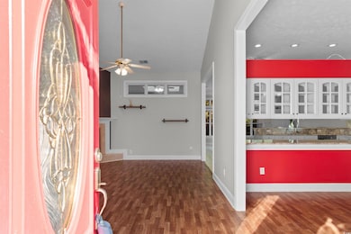 Foyer entrance featuring dark wood finished floors, ceiling fan, and recessed lighting