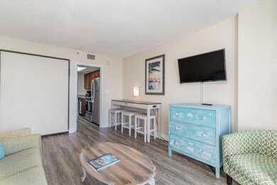 Living room with a textured ceiling and hardwood /
