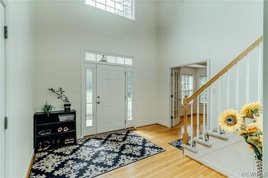 Foyer with Hardwood Floors and Entrance to the Gar
