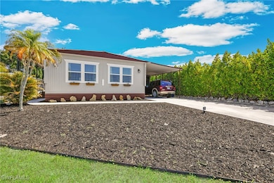 View of home's exterior featuring concrete drivewa