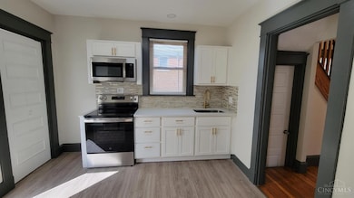 Kitchen has been completely updated. New cabinets, counter, sink, faucet, lights, and tile flooring.