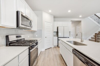 Kitchen with recessed lighting, appliances with s
