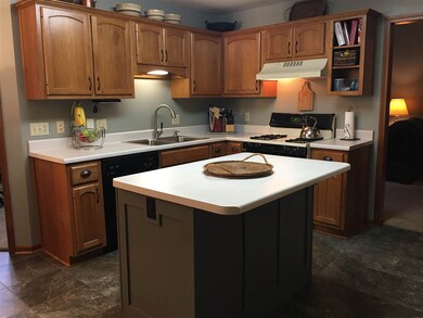 Newer flooring, newer garbage disposal, new Kitchen sink, newer lighting, and updated kitchen island.