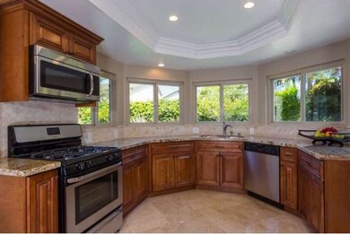 Open view kitchen with gorgeous granite and traver