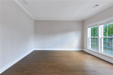 Unfurnished room featuring wood-type flooring and ornamental molding
