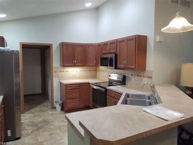 Kitchen featuring hanging light fixtures, backspla